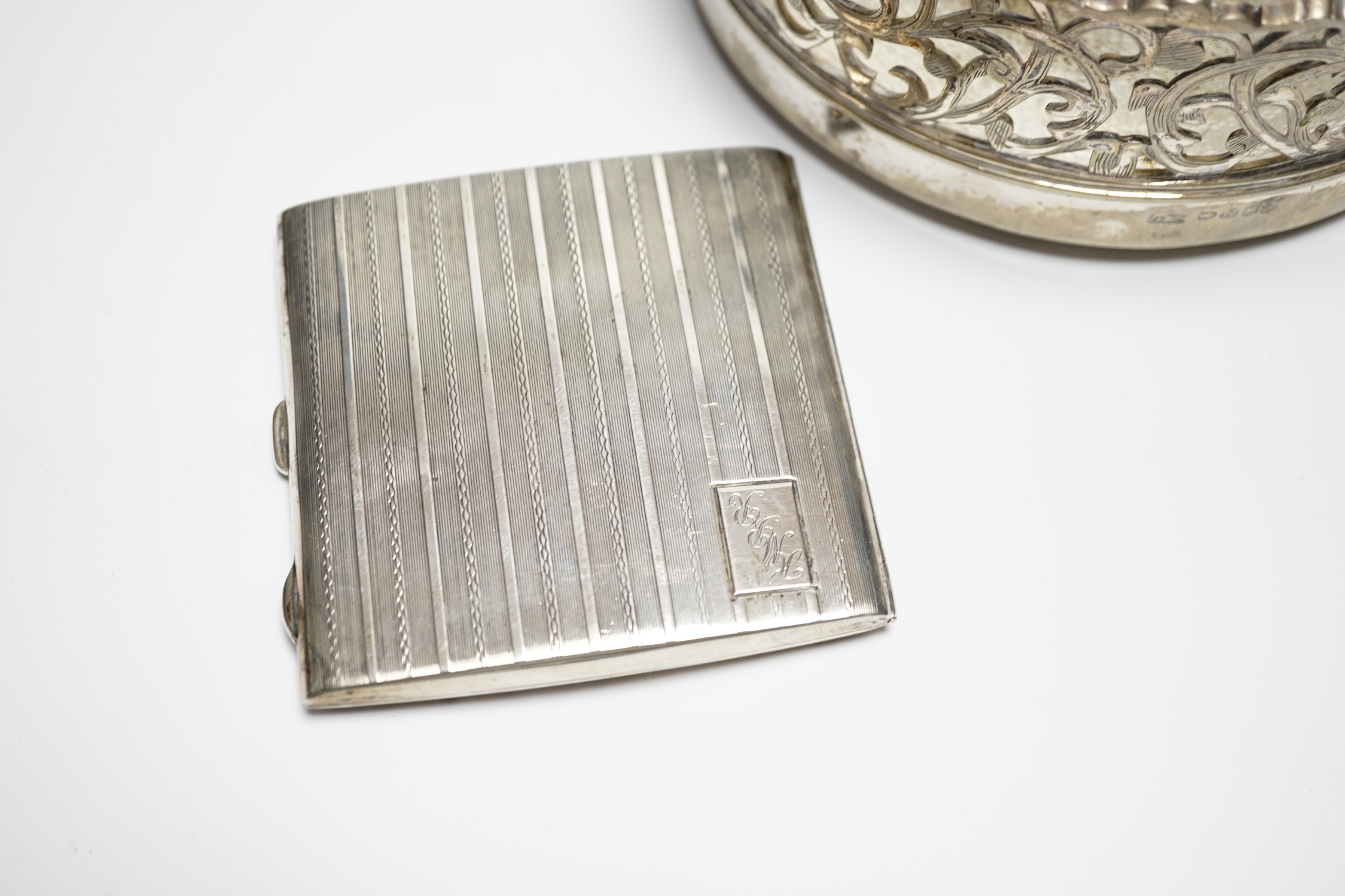A George V silver cigarette case, 82mm, a similar silver mounted cigarette box, a modern silver mounted small wine coaster and three silver plated wine coasters including a pair.